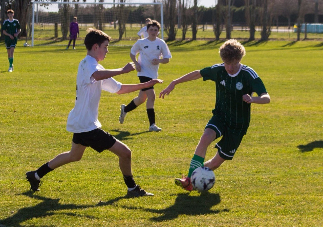 Daniel Eastmead looks to burst through Roslyn Wakari’s midfield with a powerful dribble.


