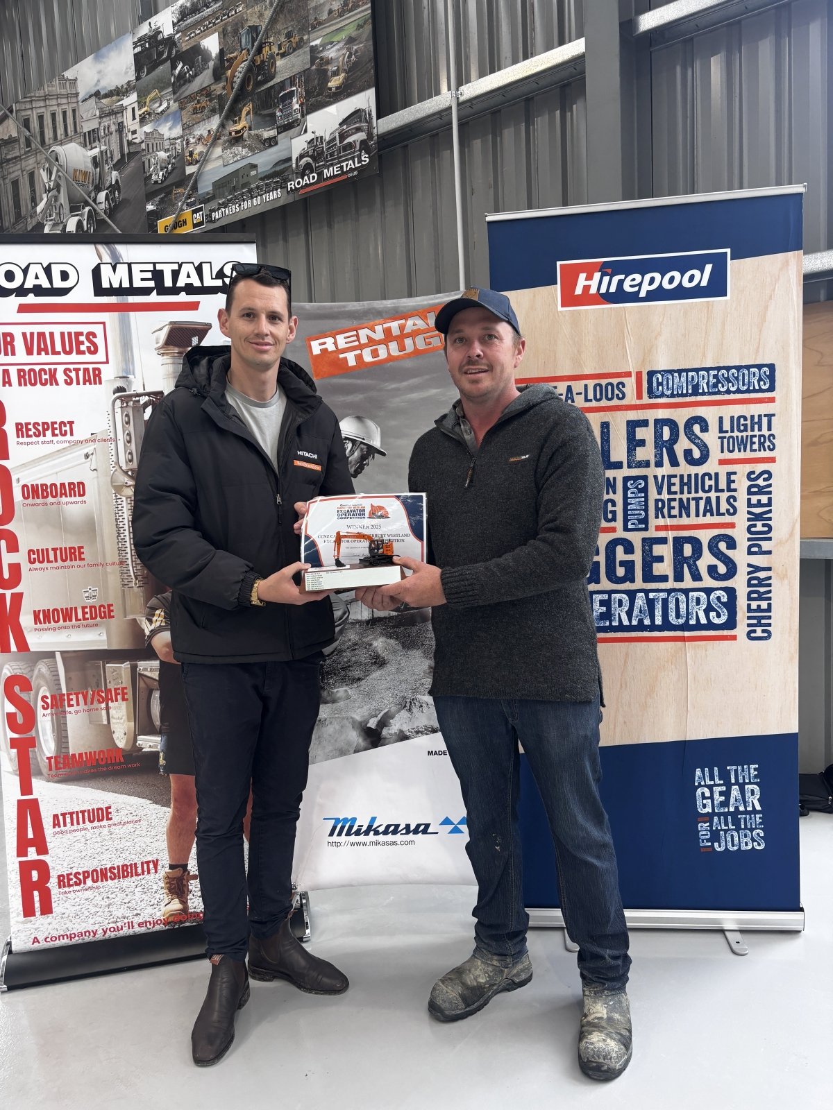 Mr Burleigh (right) receives his award from CablePrice representative Antony Robinson at the...
