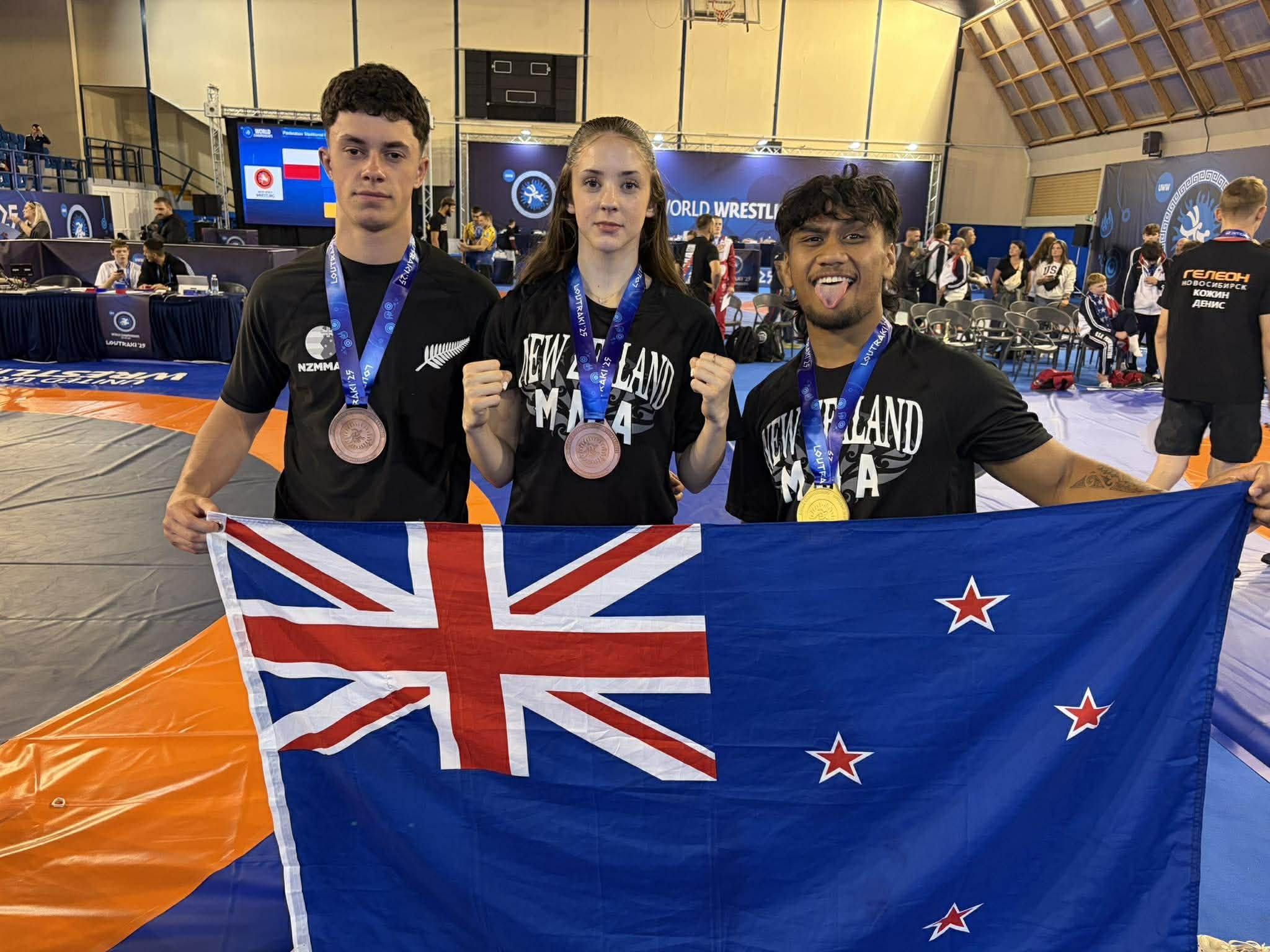 Otago duo Isaac McLaughlin and Shyla Mulholland, and New Zealand team-mate Eddie Samau, celebrate...
