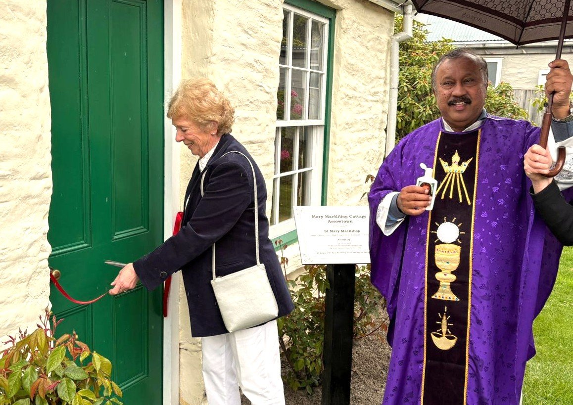 Queenstown & District Historical Society member Denise Heckler cuts the ribbon to the refurbished...