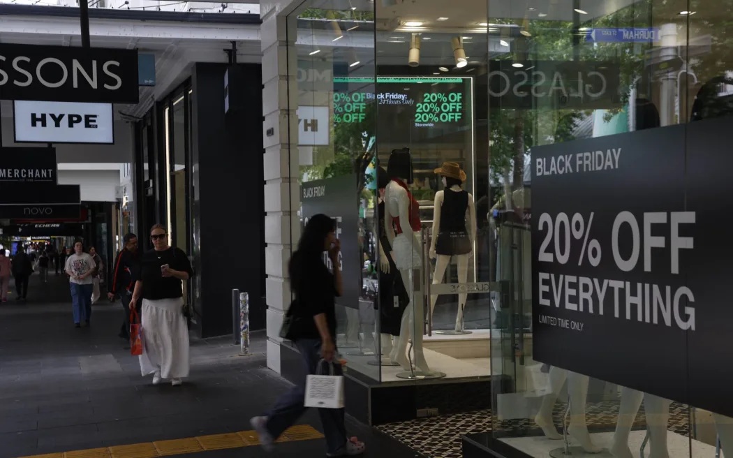 Shops on Auckland's Queen St promote their Black Friday deals. Photo: RNZ