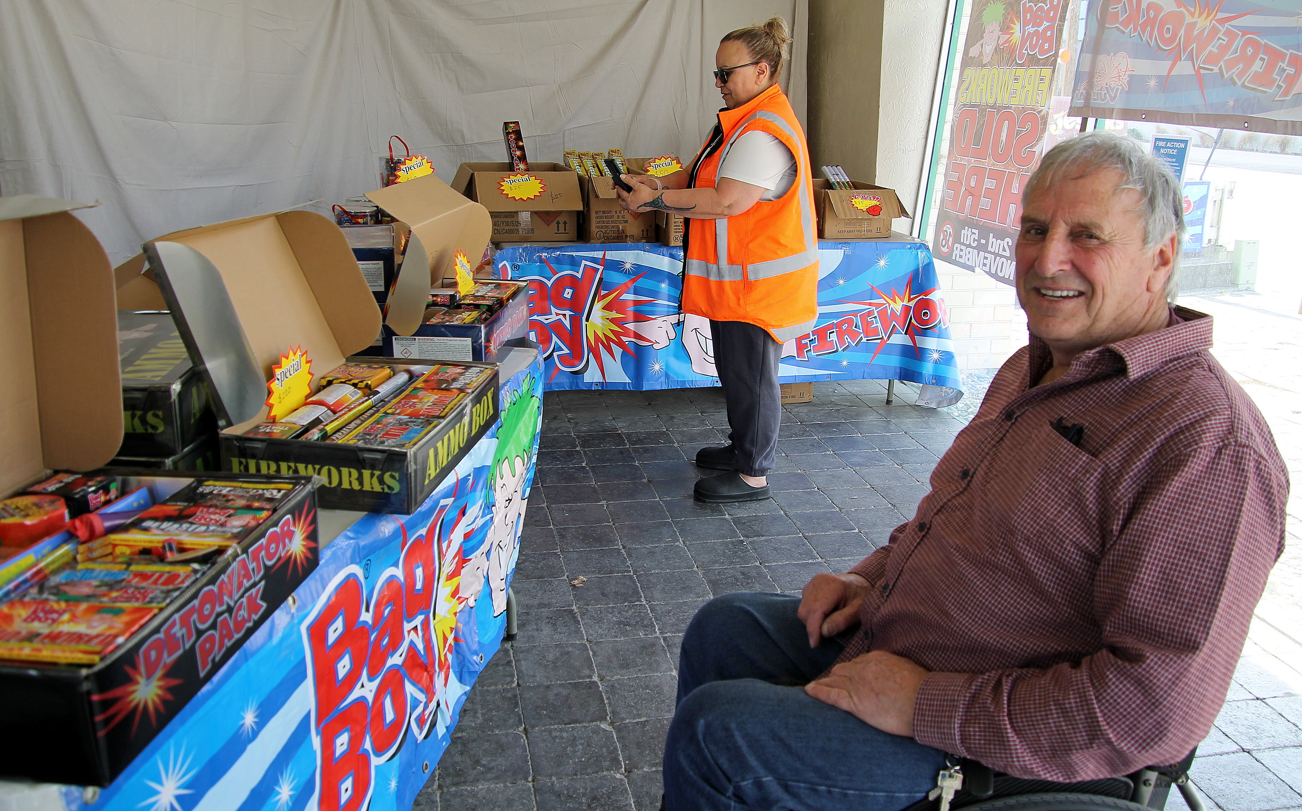 Pip Martin (foreground) takes care of business at Balclutha’s Bad Boy Fireworks pop-up shop,...
