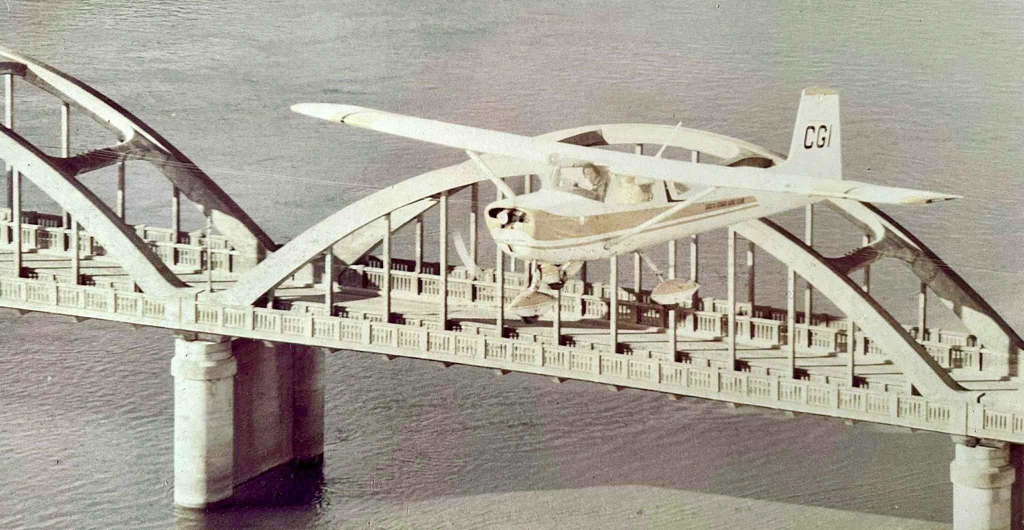 A South Otago Aero Club pilot buzzes a Cessna 150 CGI over the Balclutha Bridge in the late 1970s...