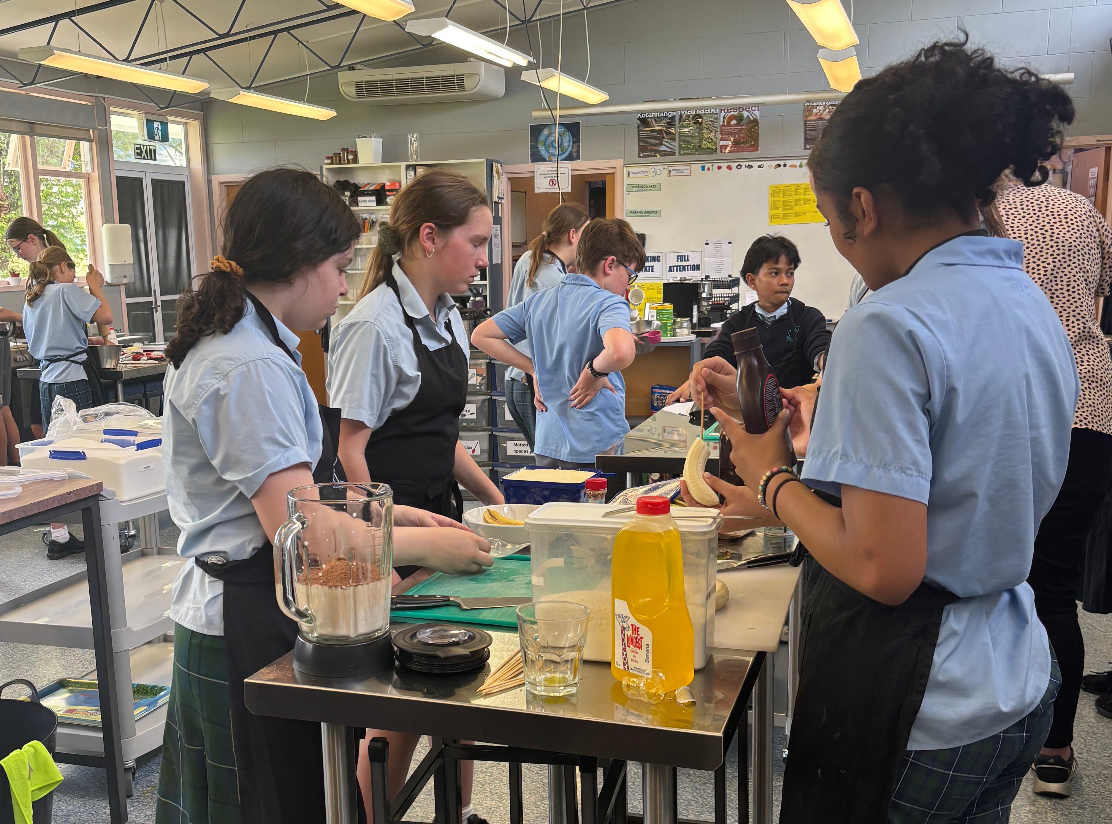 The same food room in 2025 with (nearest camera, from left) Rhea Lomas, Emma Henton, Kahu...