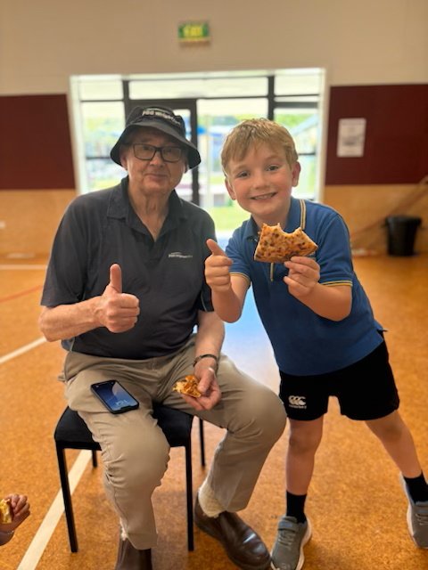 Seven-year-old Clyde School pupil Beau McMaster shares a slice of pizza with PGG Wrightson wool...