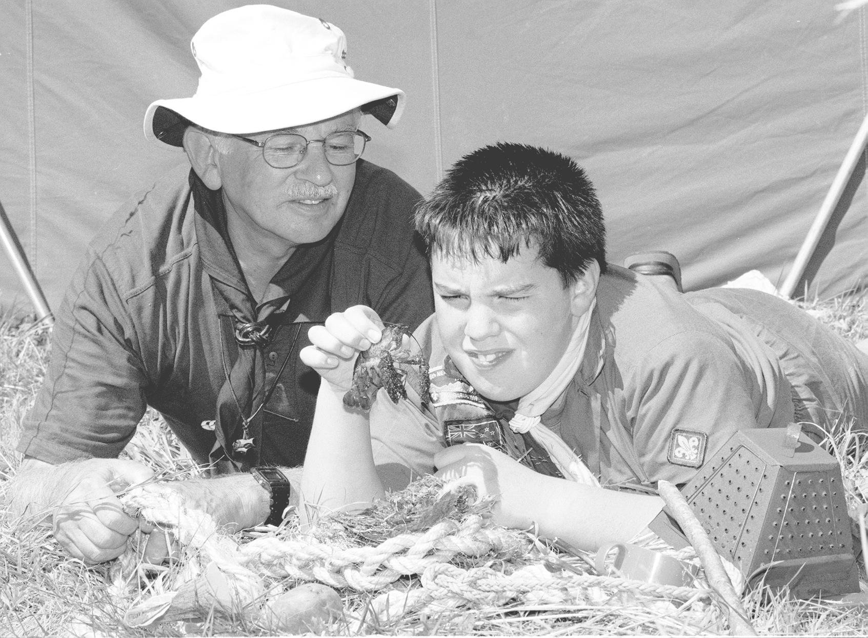 Hec Browett, then area commissioner for scouts, looks through the piles of stuff scavenged by...