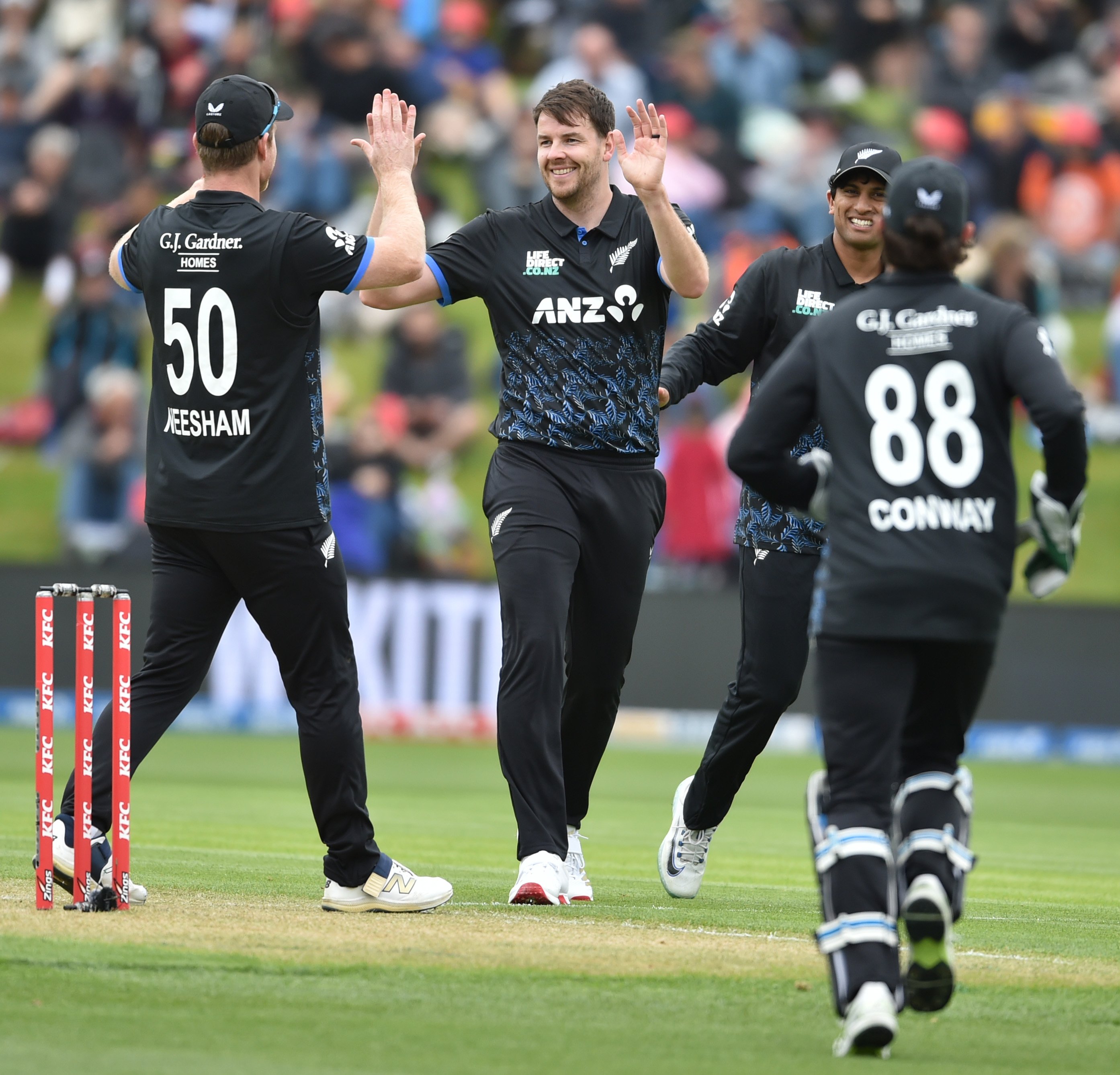 Jacob Duffy celebrates taking a West Indies wicket with team-mates (from left) Jimmy Neesham,...