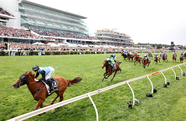 Jamie Melham rides No 14 Half Yours to win the Melbourne Cup at Flemington Racecourse in...