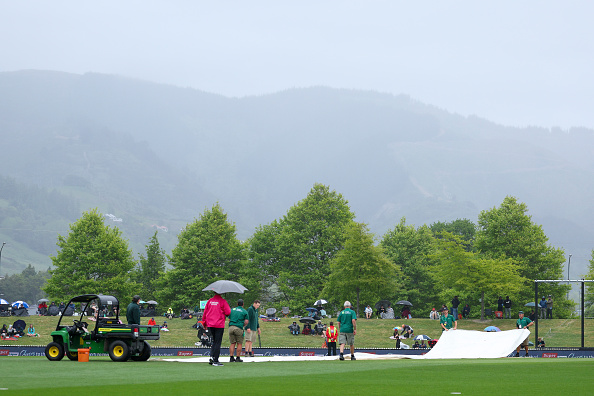 Ground staff put covers on the wicket as rain falls at Nelson's Saxton Oval today. Photo: Getty...