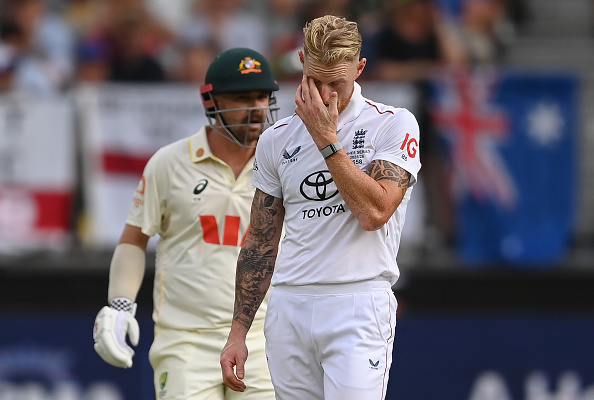 England captain Ben Stokes reacts to another Travis Head (rear) boundary during the first Ashes...