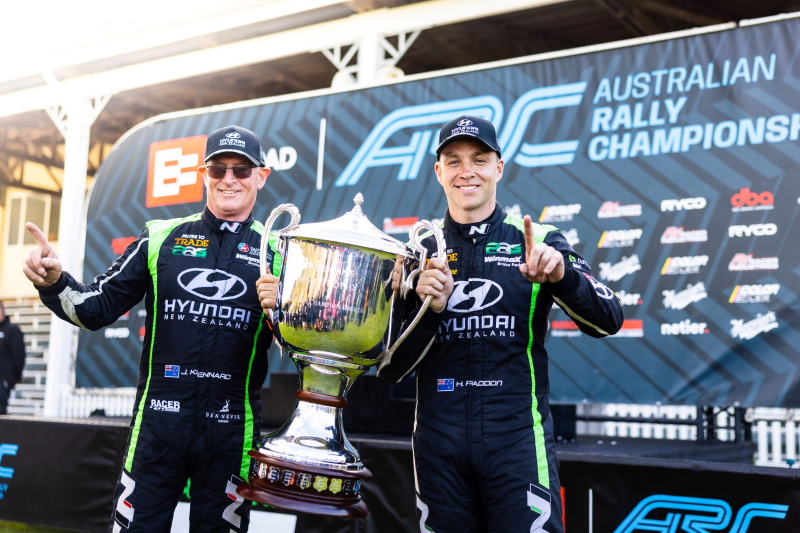 John Kennard (left) and Hayden Paddon celebrate with the Possum Bourne Trophy after winning the...