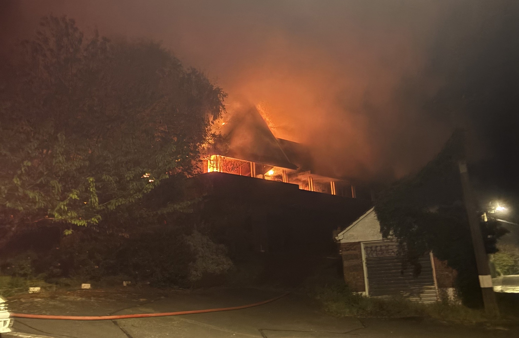 A firehose snakes up the driveway of Dunedin’s former Glamis Hospital early yesterday morning as...