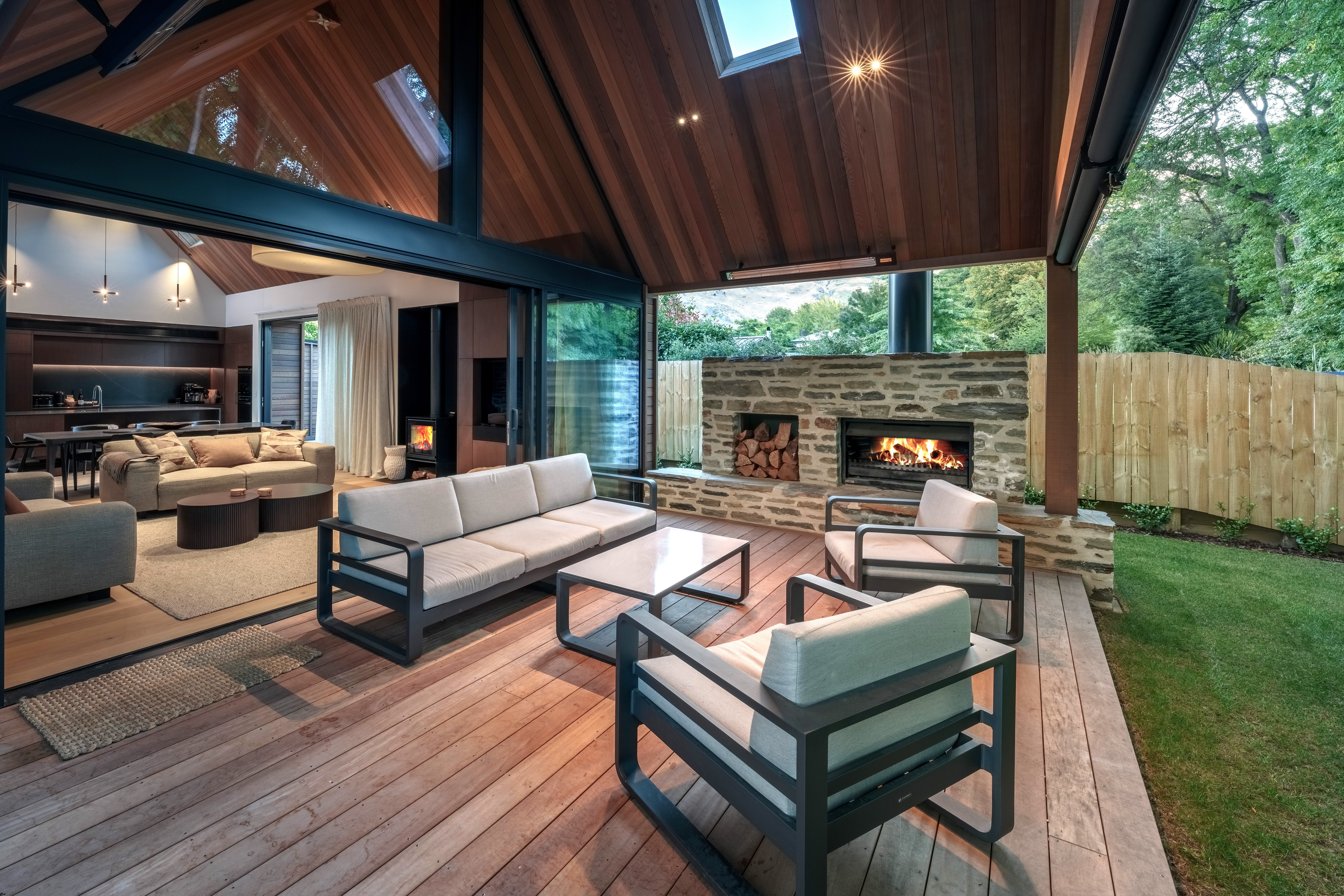 The living room extends on to a covered outdoor area, ideal for socialising and relaxation.