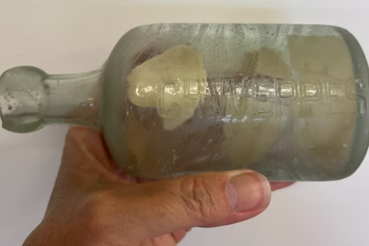 The Esperance family who found the bottle had to use tweezers to remove the letter. Photo:...