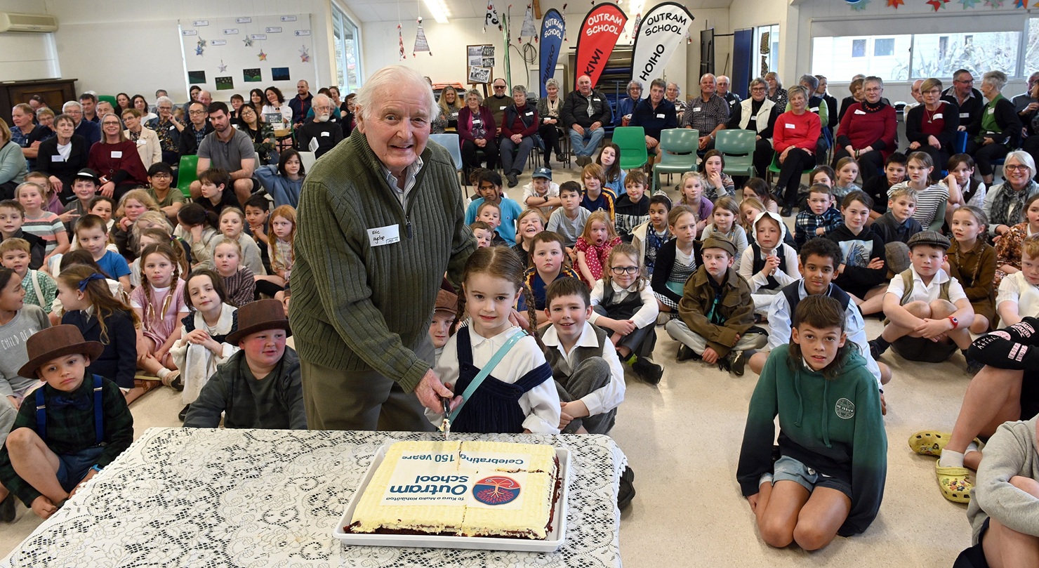Outram School’s then oldest ex-pupil Eric Hyslop (pictured in 2023, aged 94) cuts the cake at the...