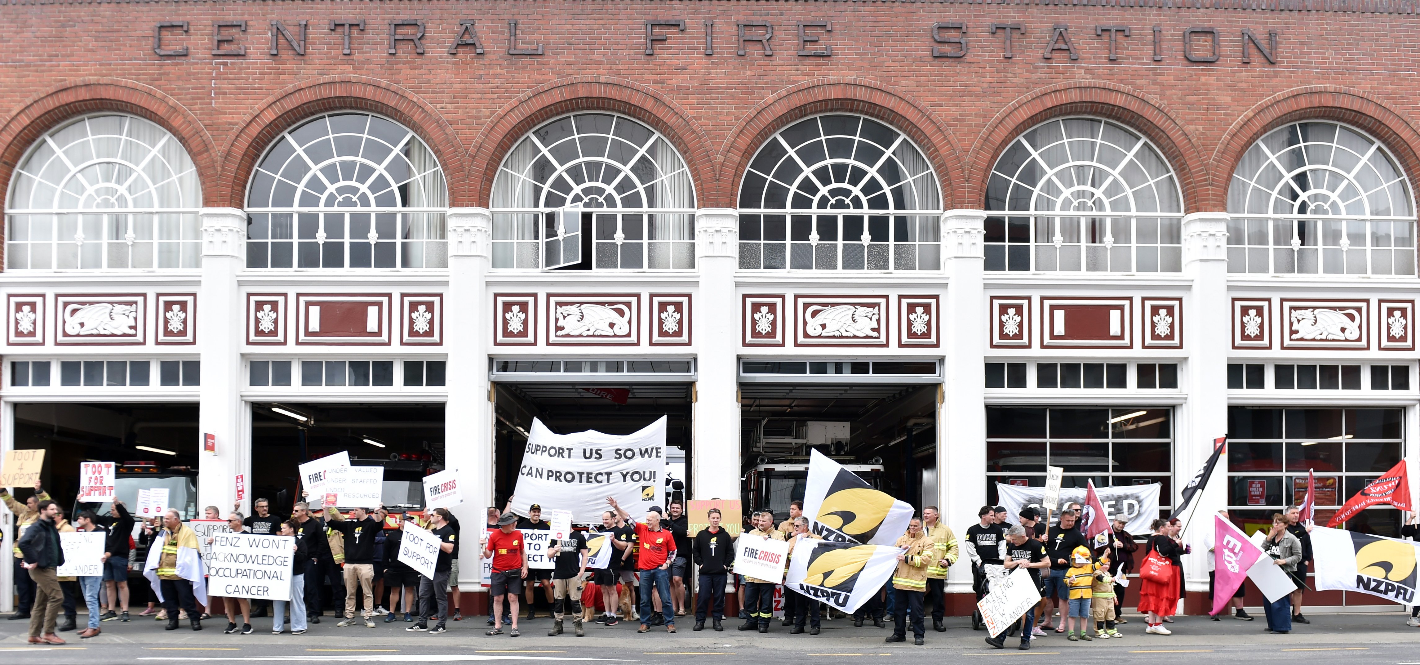Firefighters and supporters gather outside the Dunedin Central Fire Station during yesterday’s...