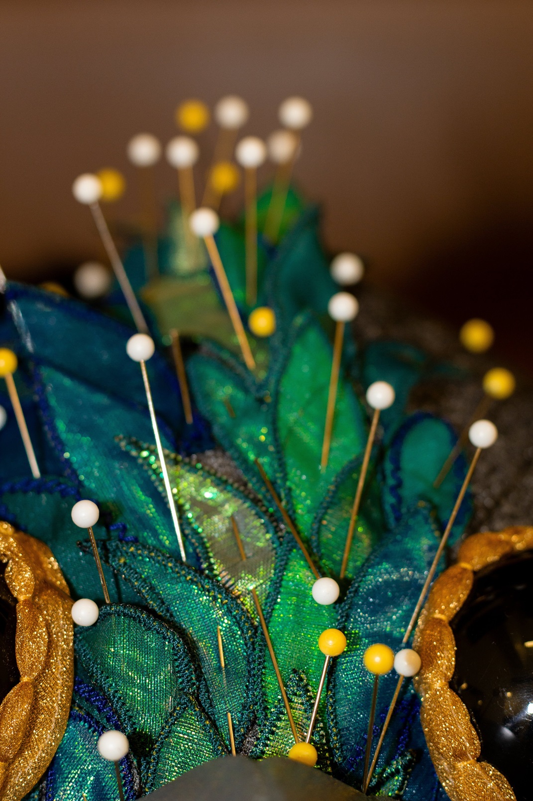 The painstaking process to layer features on the bird headpieces such as the kererū. Photo: RNZB