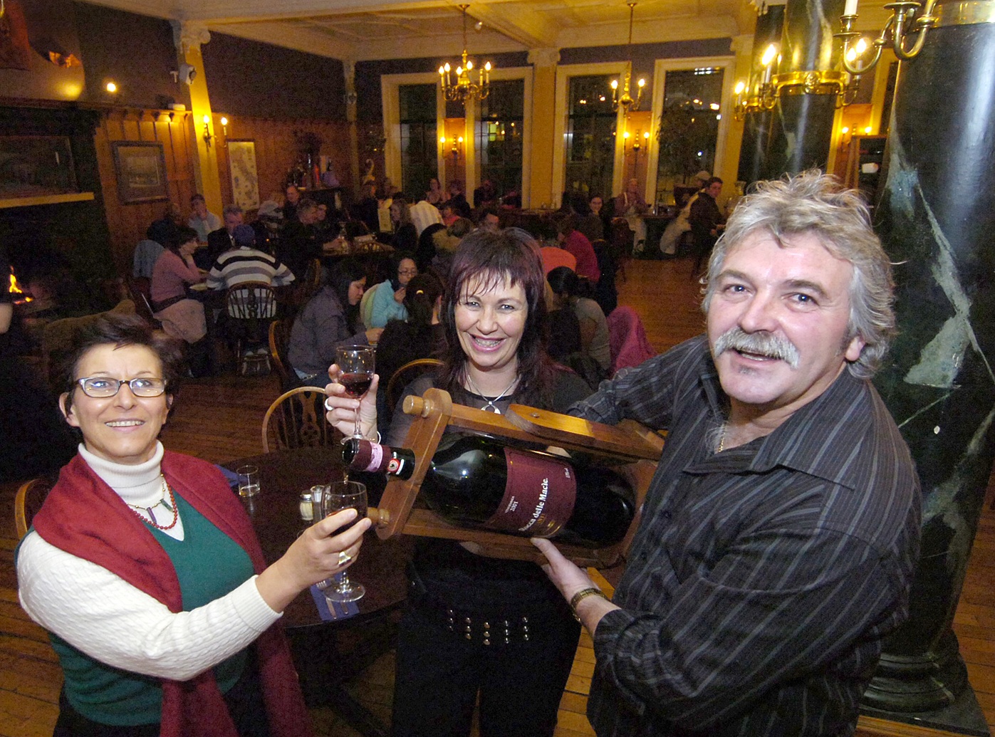 Federico, with Meegan (middle) pours a free red wine for diner Francesca Ghisetti at Etrusco in...