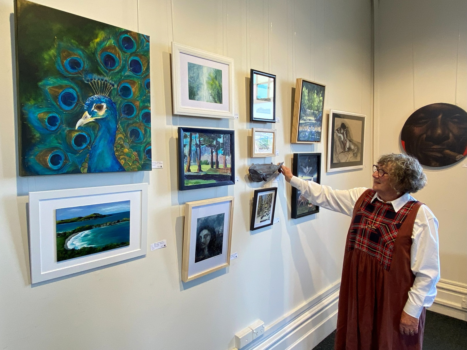 Otago Art Society "Art to Go" exhibition co-ordinator Gill Adank looks over some of the 176 works...