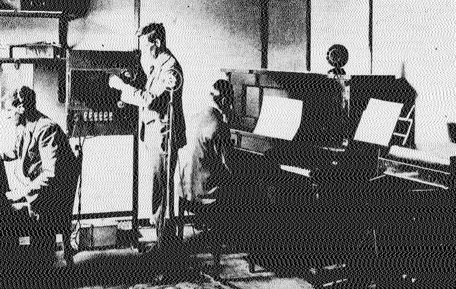 Public broadcasting begins. Operator Bill Huggins, engineer Jack Bingham and musical director and...