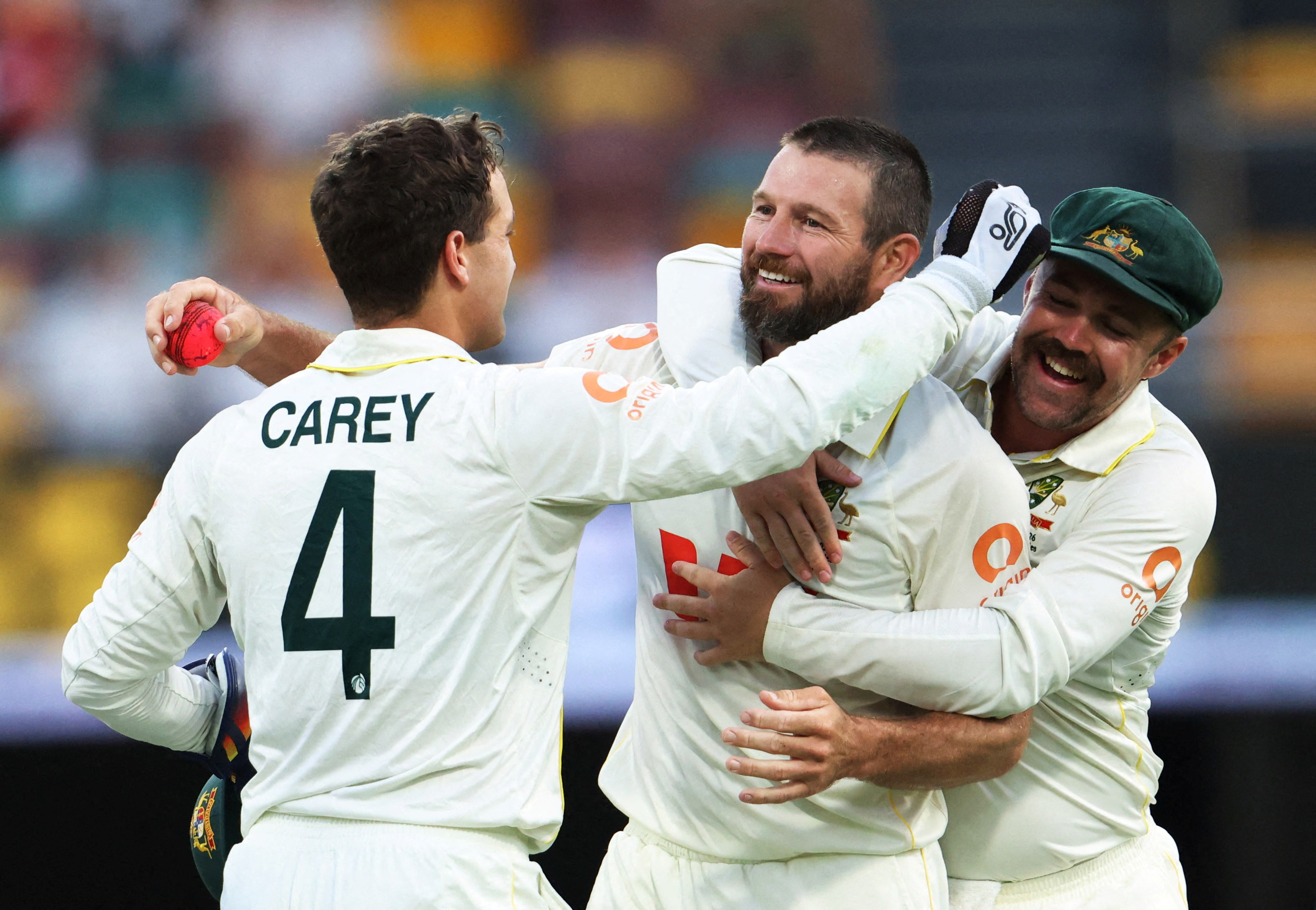 Michael Neser (centre) celebrates a five-wicket haul with teammates Alex Carey (left) and Travis...