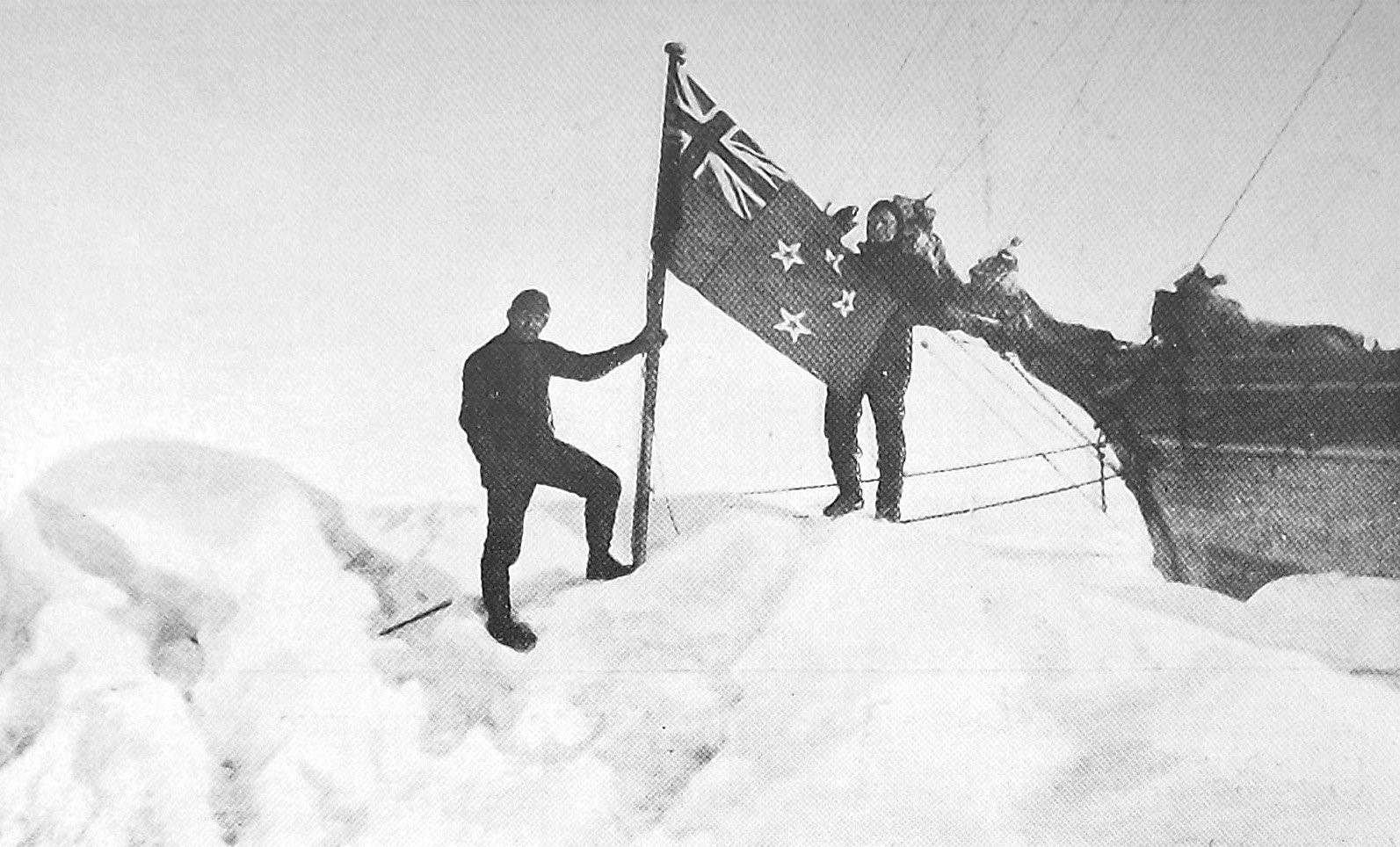 Ship’s engineer Gordon Burt, of Dunedin, holds the New Zealand flag alongside exploration ship...