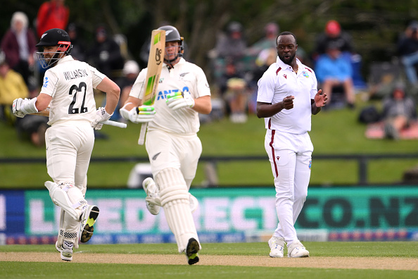 West Indies bowler Kemar Roach  reacts as Kane Williamson and Tom Latham score some runs for the...