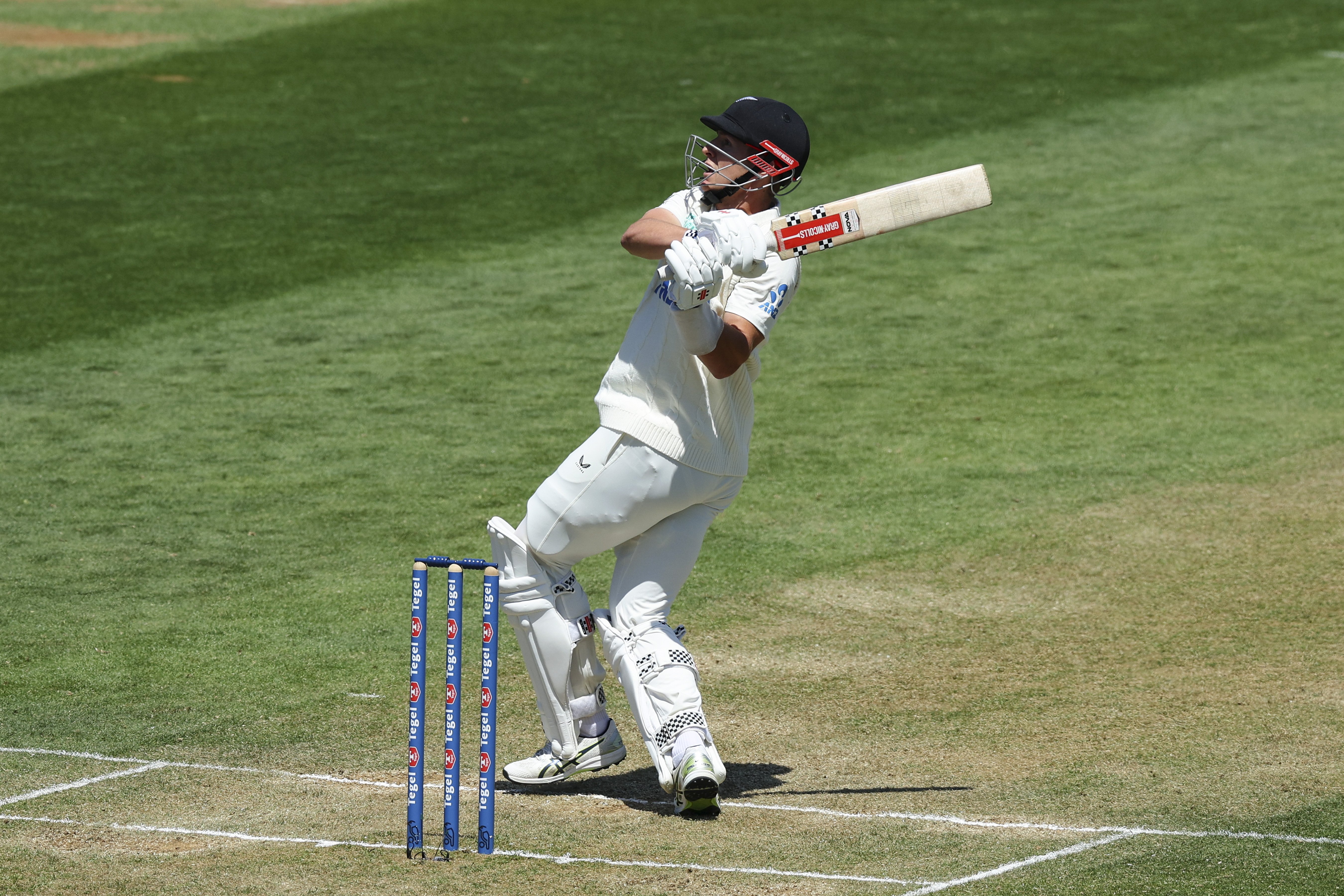 The Black Caps’ Mitch Hay puts one over the rope during his debut test innings of 61 during day...
