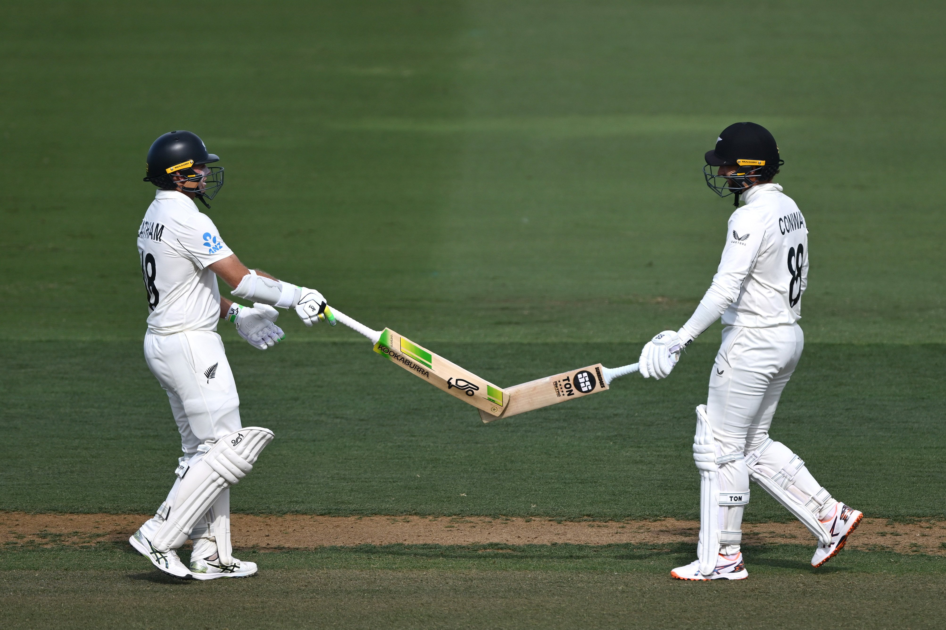 Black Cap openers Tom Latham (left) and Devon Conway celebrate their record partnership on day...