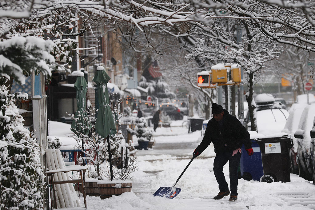 A man shovels snow in the New York borough of Brooklyn after an overnight storm in the city....