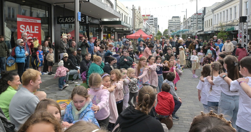 Children form a train as they dance during New Year's Eve celebrations at George St. Photo:...