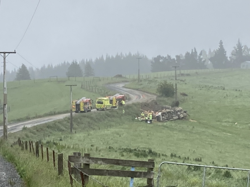 Emergency services attend the scene of the logging truck crash which left a person trapped at...