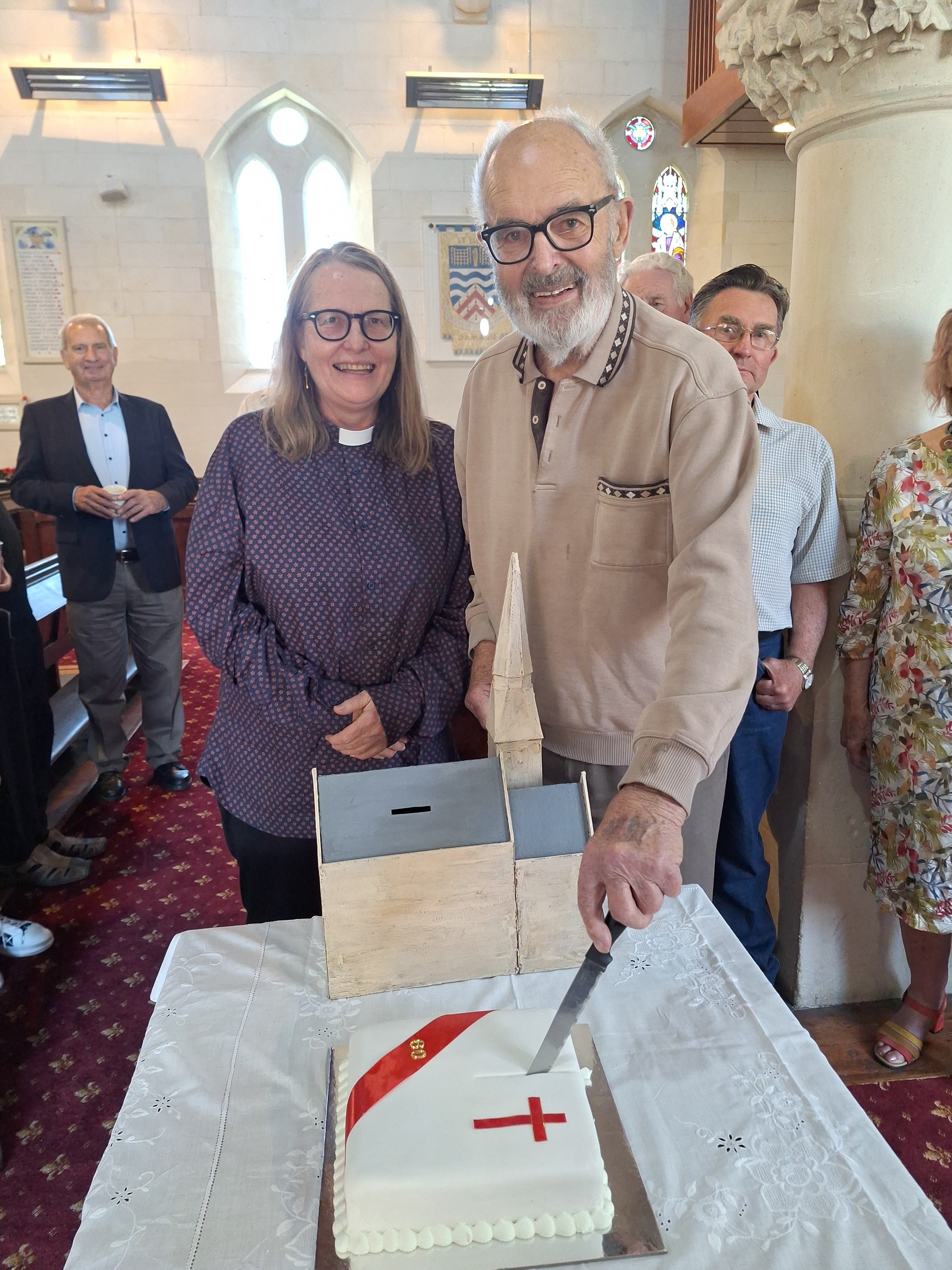 Archdeacon The Ven Bernard Wilkinson with St Luke’s vicar he Rev Andrea McDougall cuts the...