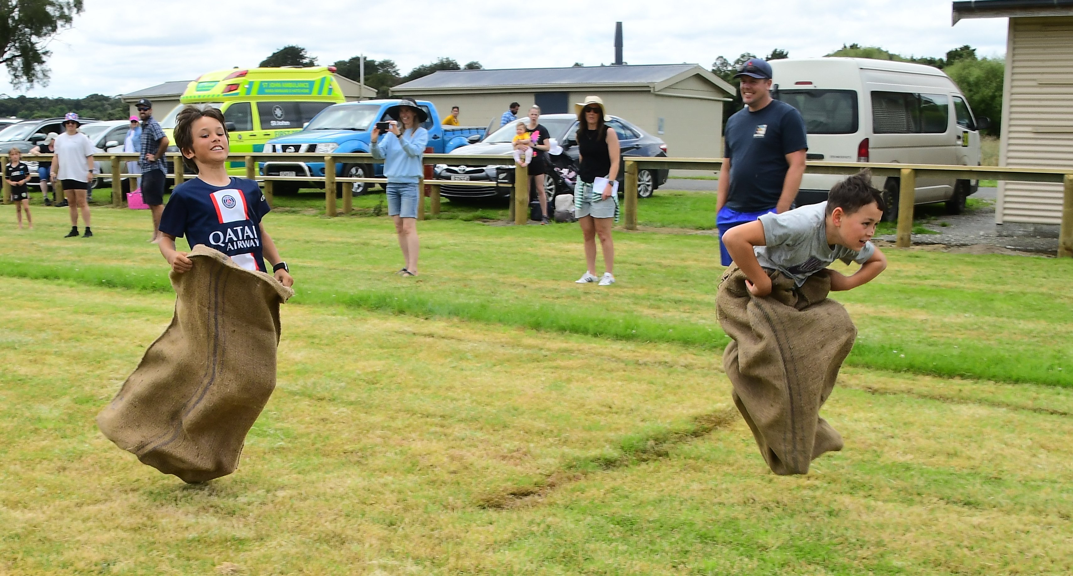 Ali Peterson, then aged 10 (right), of Riverton, jumps to a win in a sack race at the New Year’s...