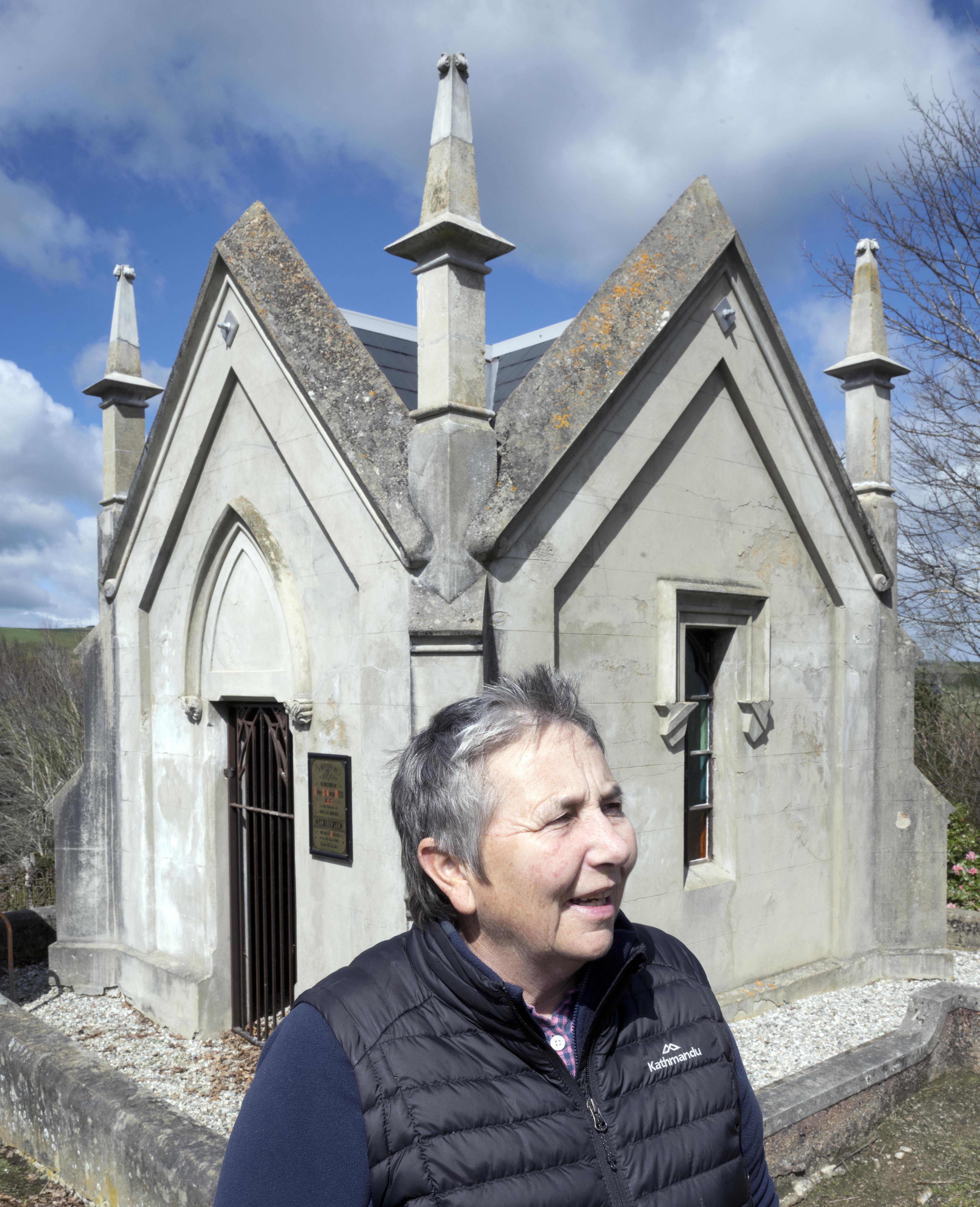 Project leader Adrienne Shaw at the restored Sam Chew Lain tomb in Lawrence, which has just...