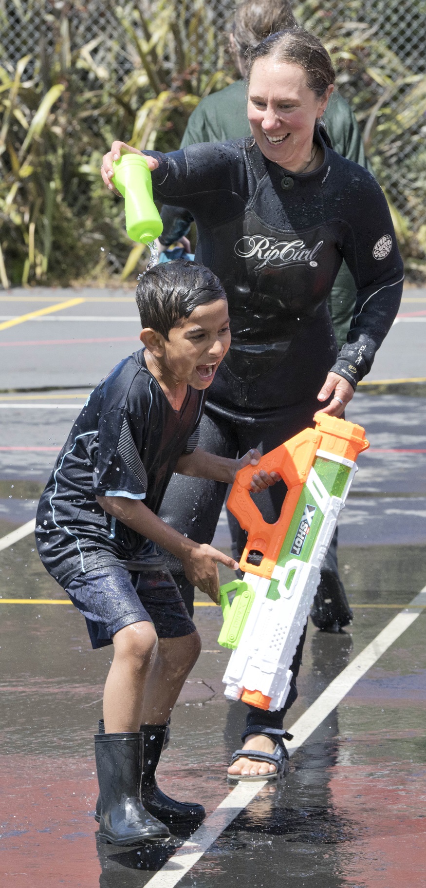 St Leonard’s School year 2 pupil Muhammad Rohaan Saleem, 7, gets sprayed by his principal Sarah...