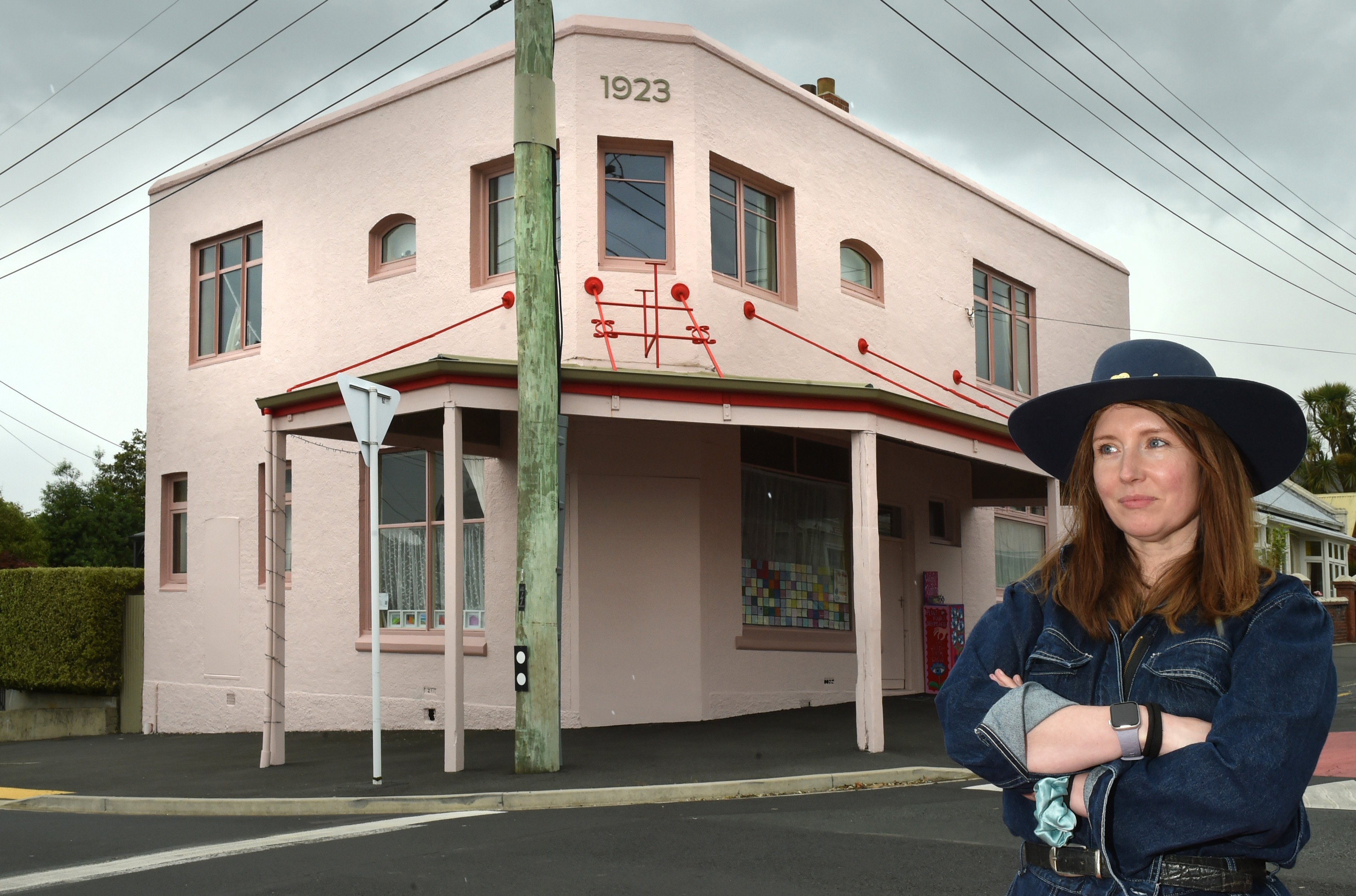 Tansy Hayden outside the now-pink former corner shop and upstairs dwelling, built for storekeeper...