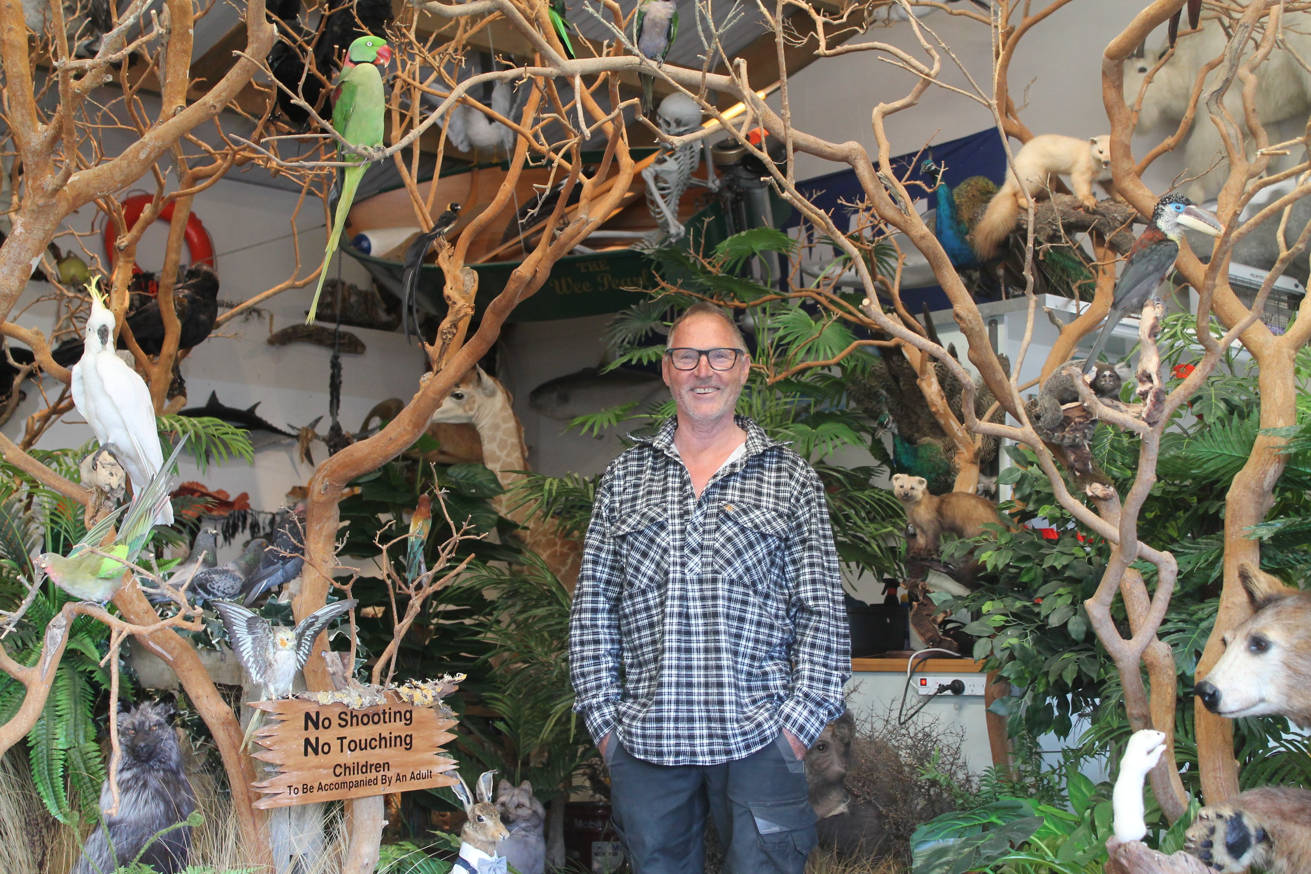 Mike Rodgers surrounded by his more than 300-piece taxidermy collection in his home in East Gore....