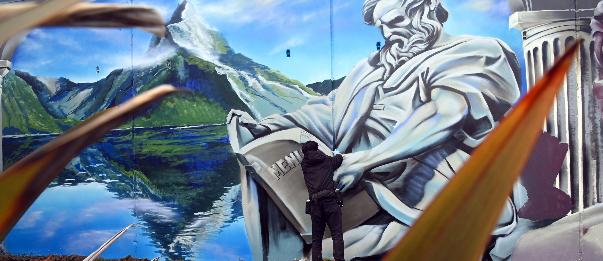 Artist Koryu Aoshima puts some finishing touches on his mural in Te Anau on Saturday.