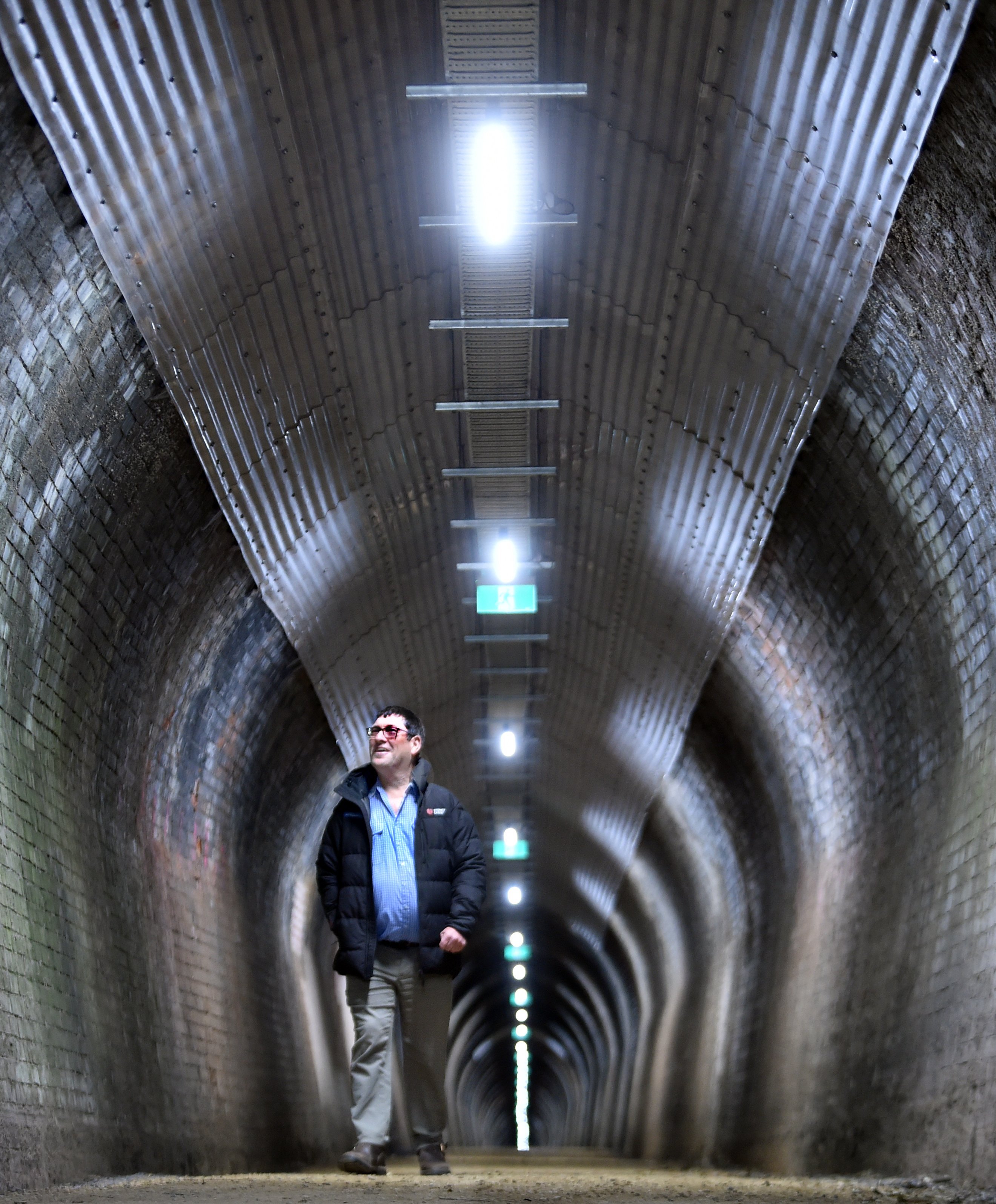 Dunedin Tunnels Trail Trust chairman Brent Irving has a look around the Chain Hills Tunnel after...