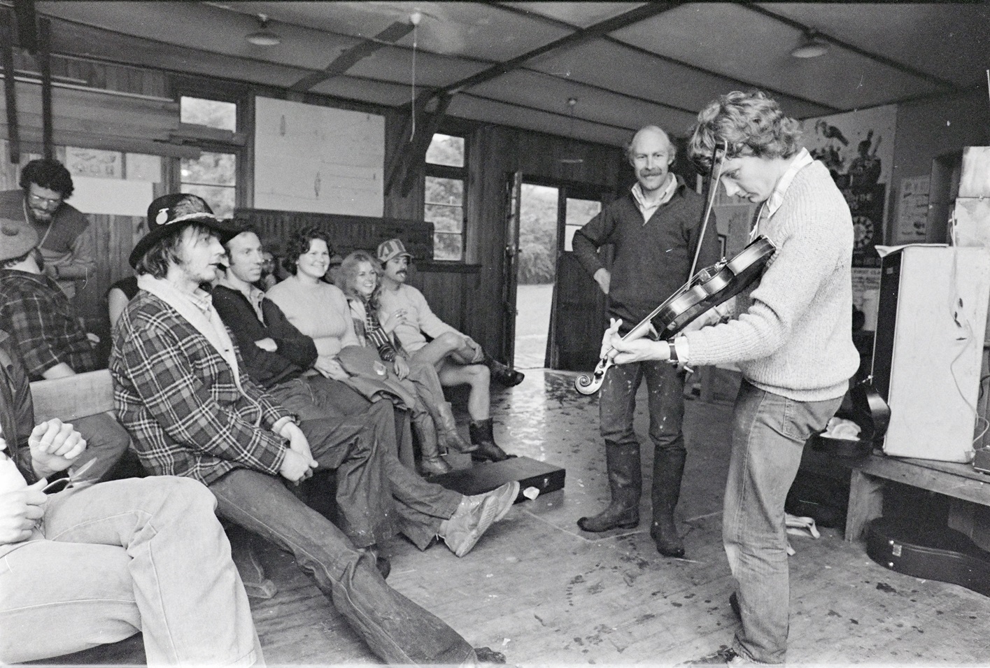 Plucking the strings of his fiddle in 1979 is Marcus Turner under the appreciative eye of Bruce...