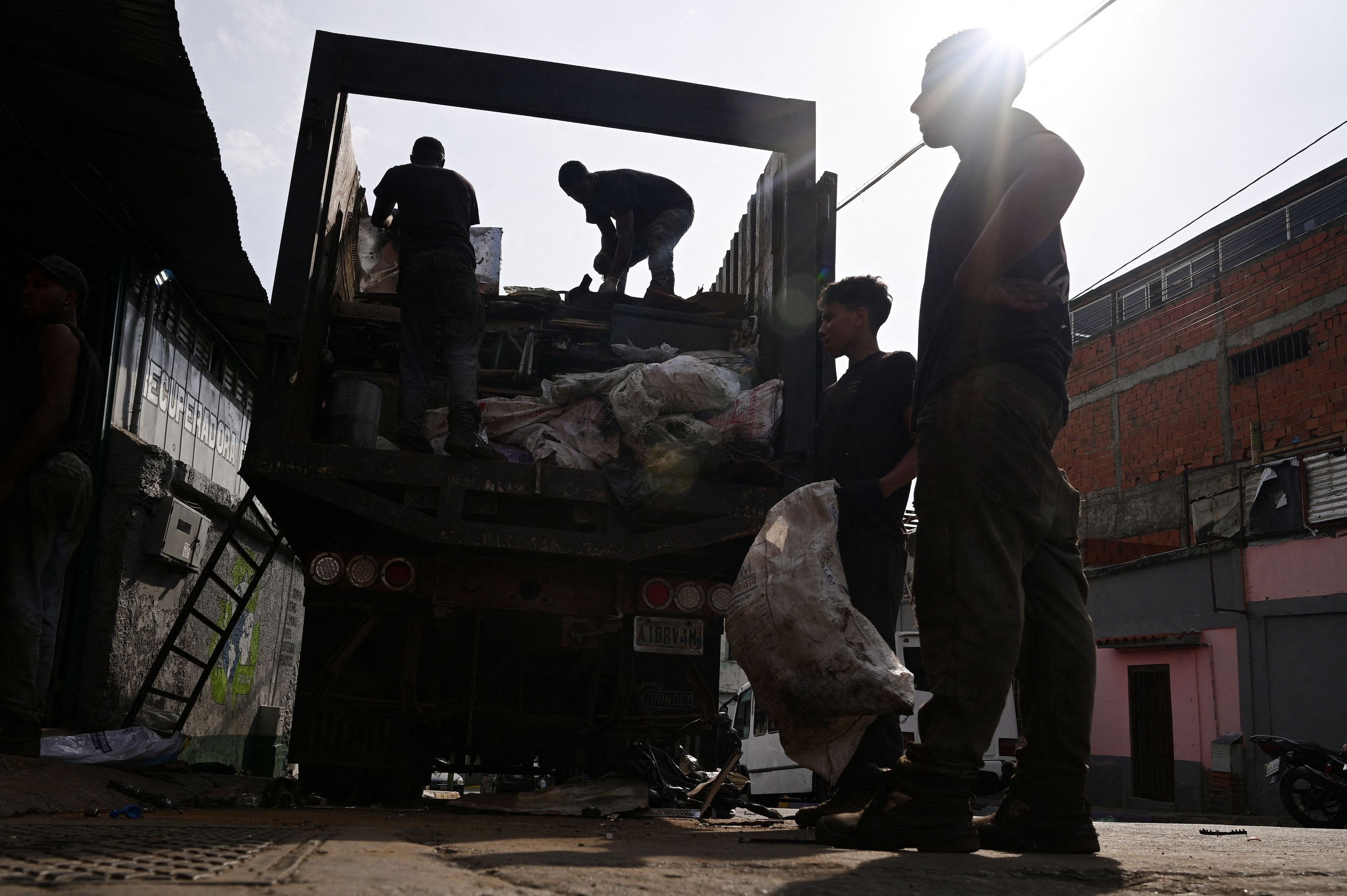 Workers sort waste at a recycling centre in Caracas, Venezuela, on Tuesday as daily life...
