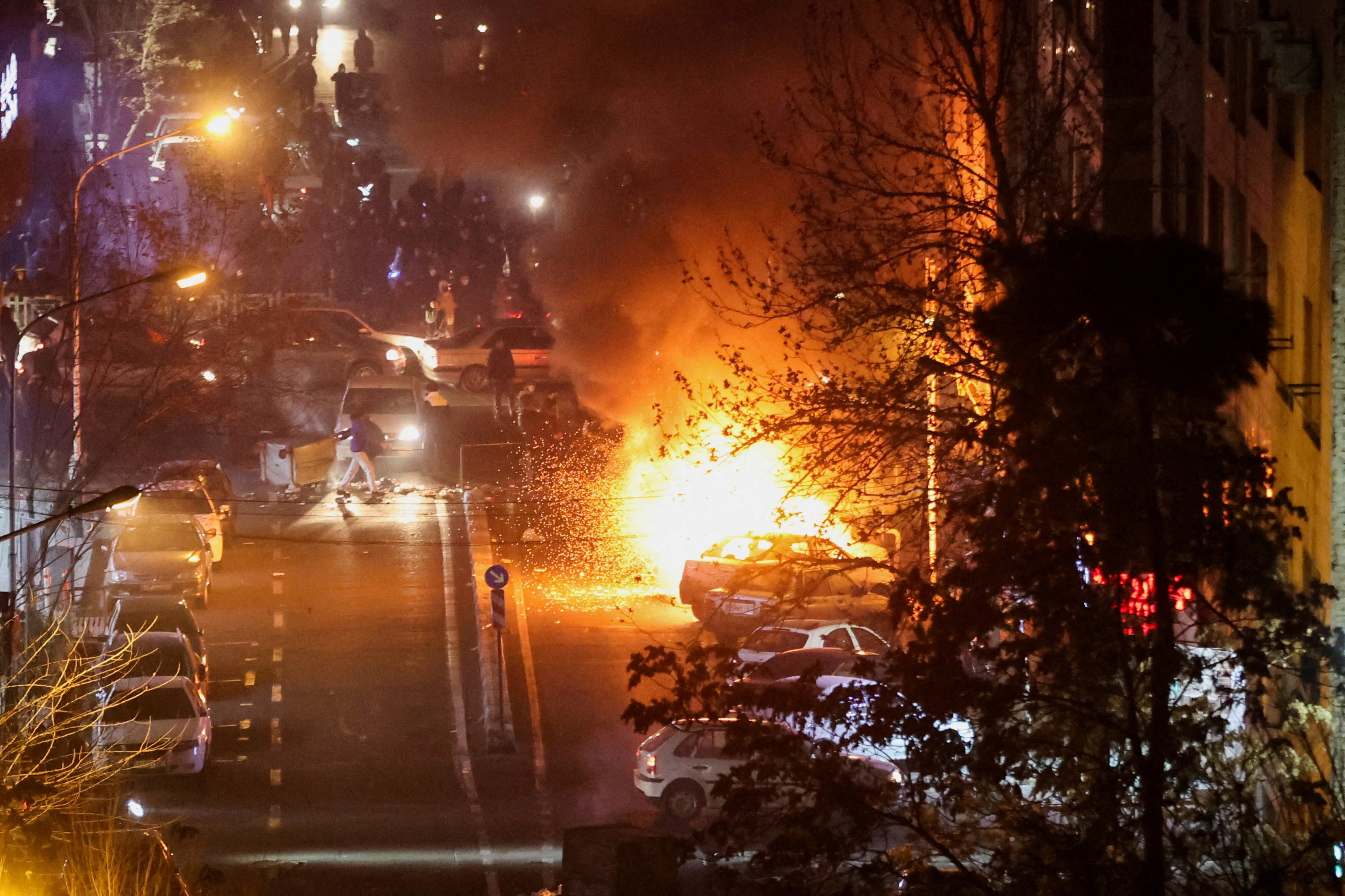 Cars burn in a street during a protest in Iran’s capital Tehran earlier this month over the...