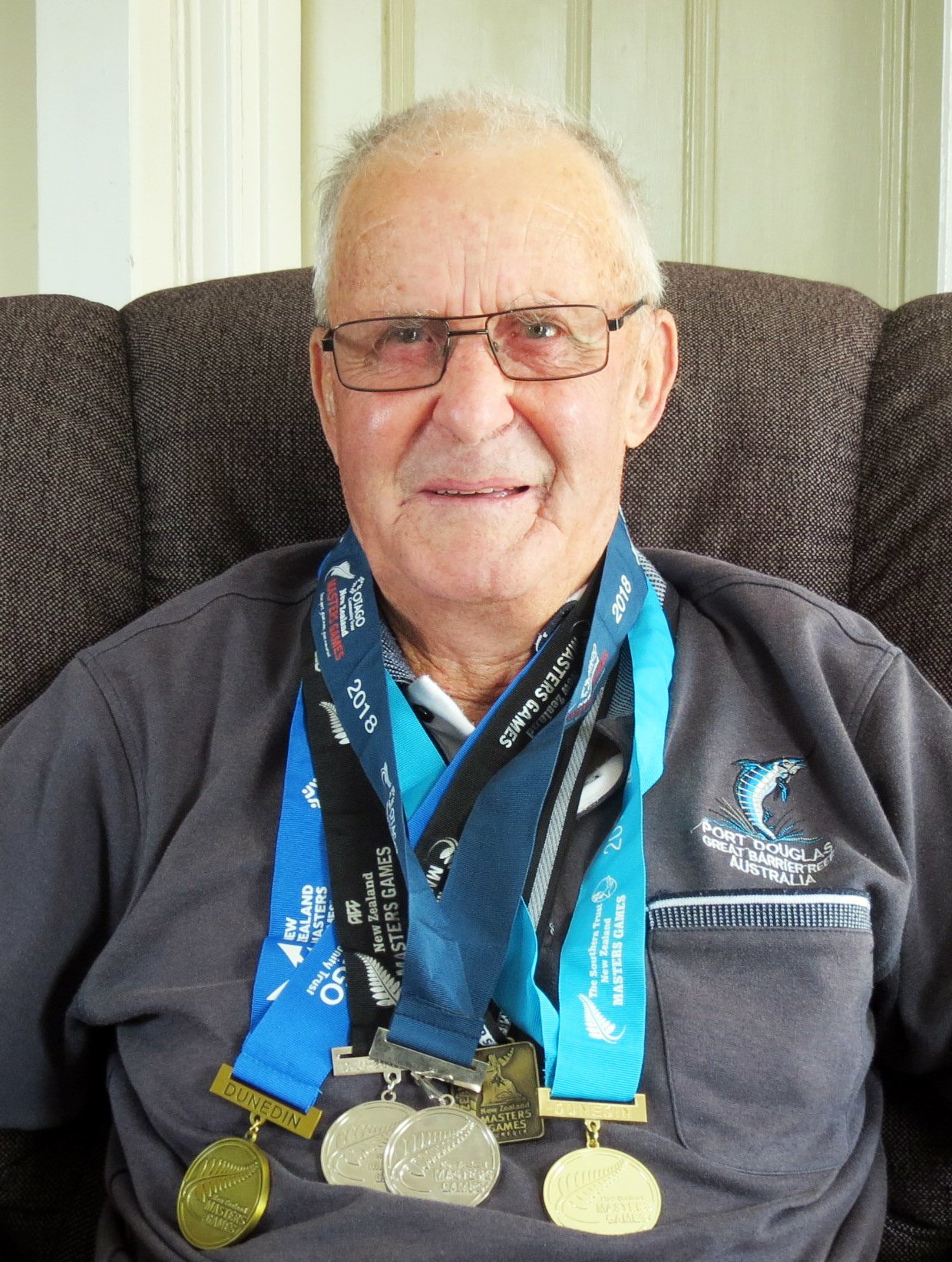 Masters Games curler Merv Jamieson, of Naseby, and the medals he won over the years. Photo: Ella...