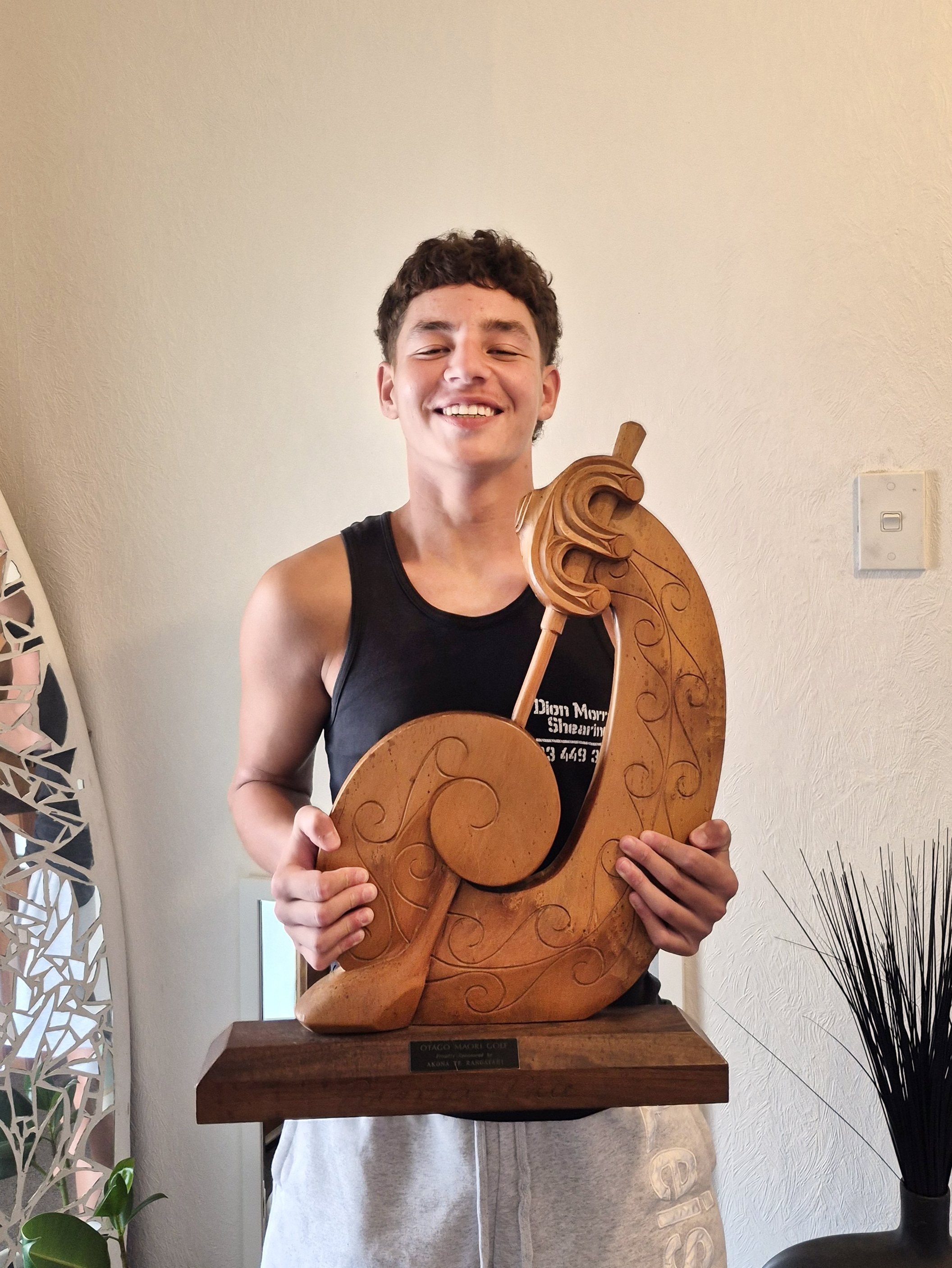 Roxburgh teenager Trey Whitu shows off the trophy he won at the Otago Māori Golf tournament last...