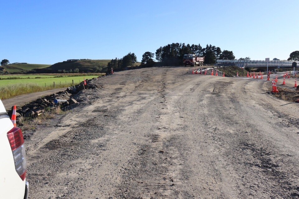 The east ern approach to the existing bridge is under traffic light control. 