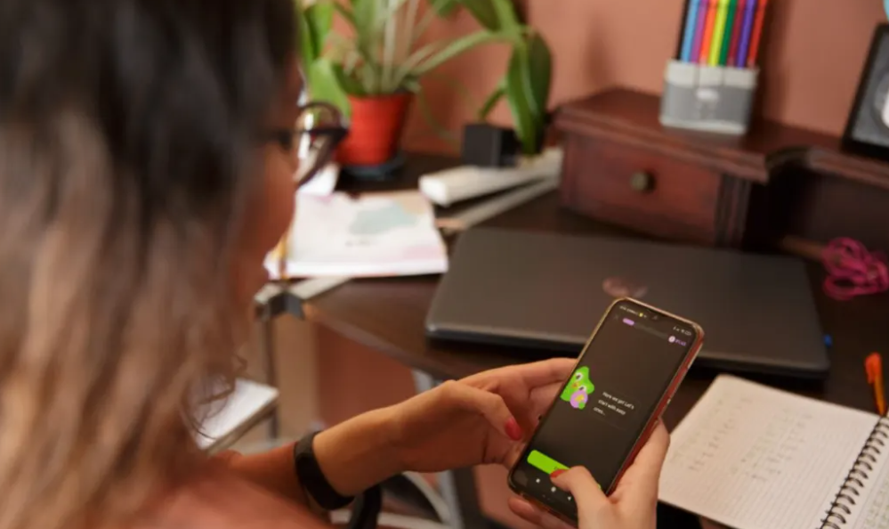 A woman uses the Duolingo app. Photo: Supplied / Duolingo