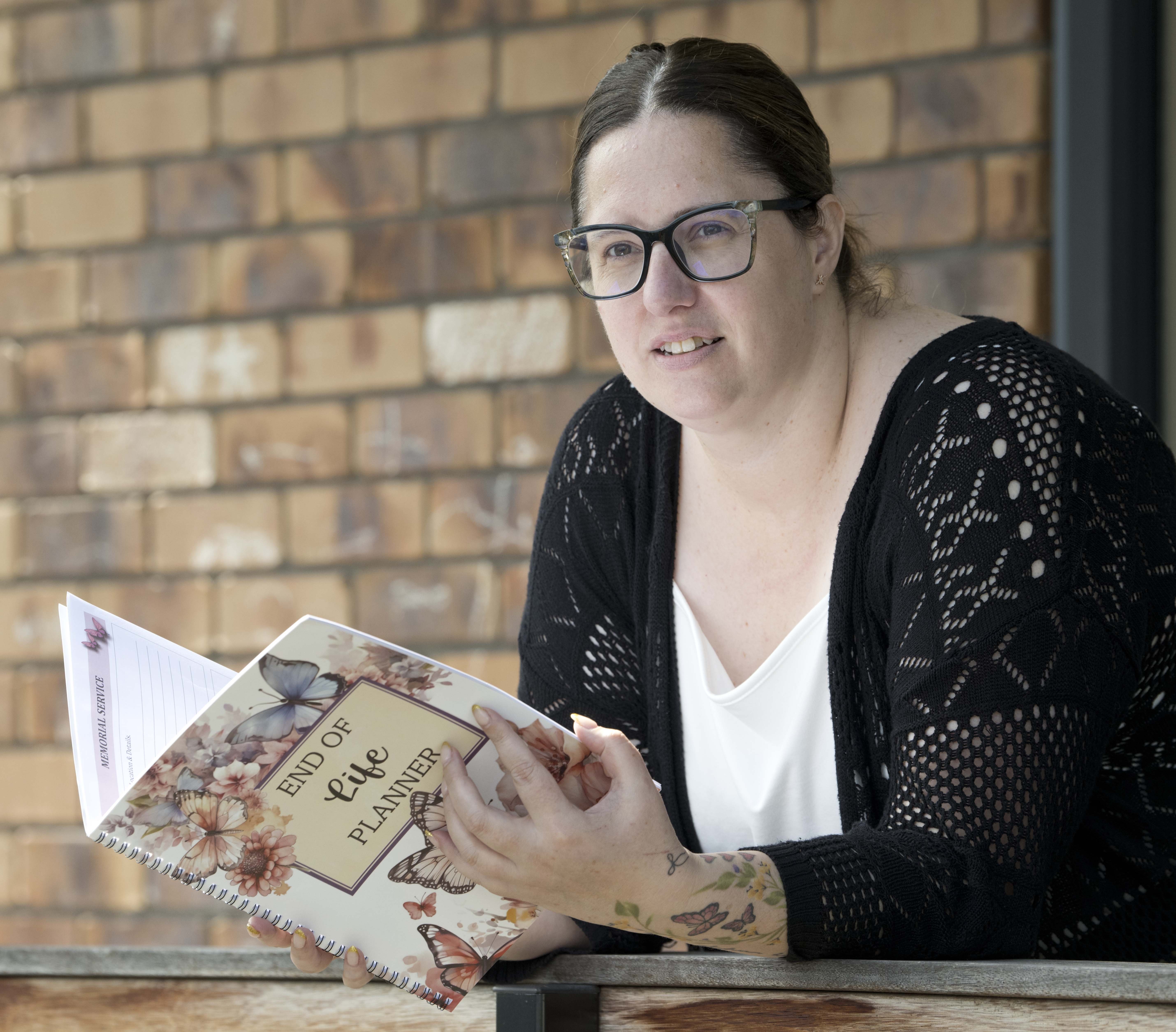 Dunedin doula Kalla Byrne thumbs through an end-of-life planner. PHOTO: GERARD O’BRIEN