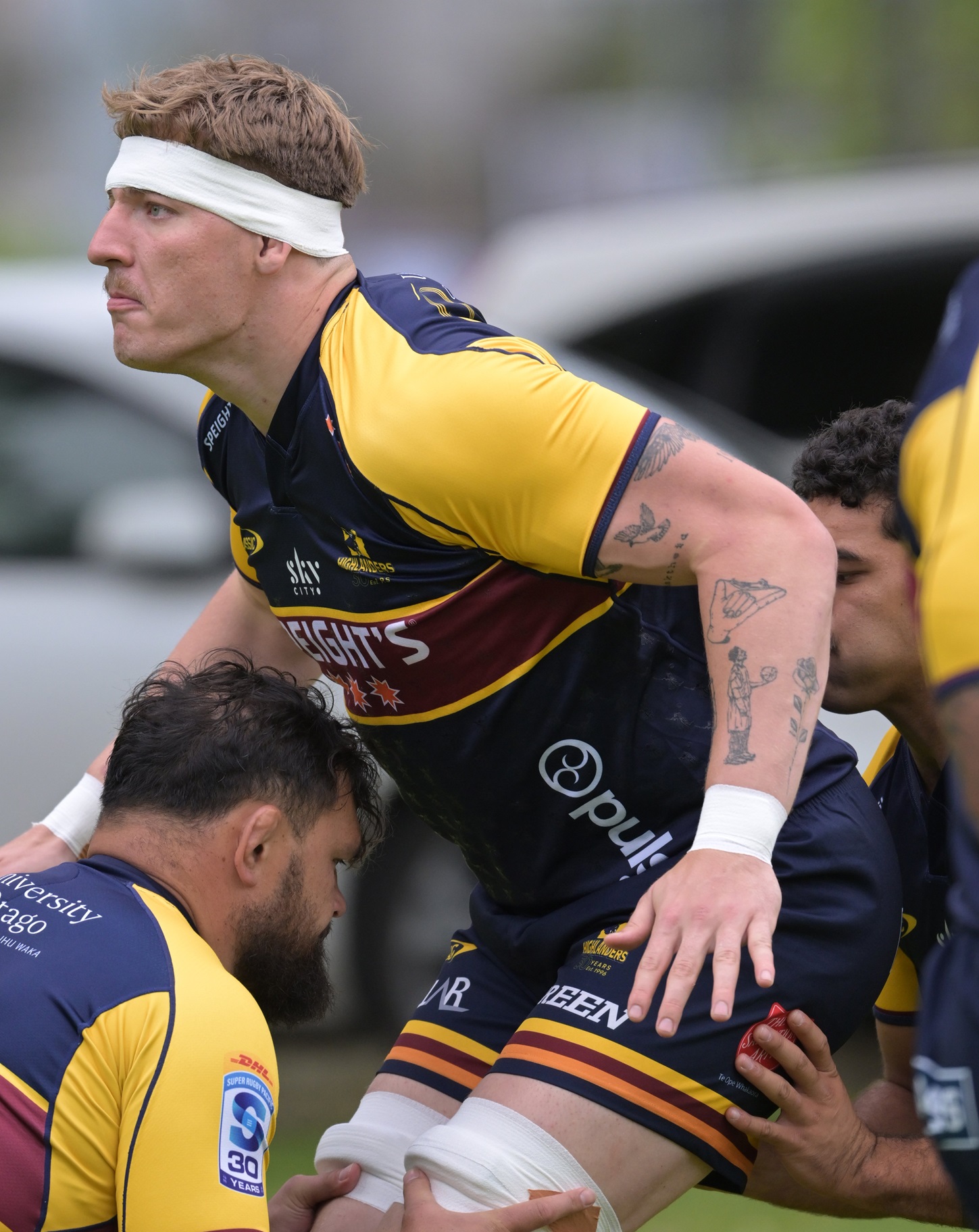 Fabian Holland prepares to be lifted by Highlanders team-mates Angus Ta’avao (left) and TK Howden...