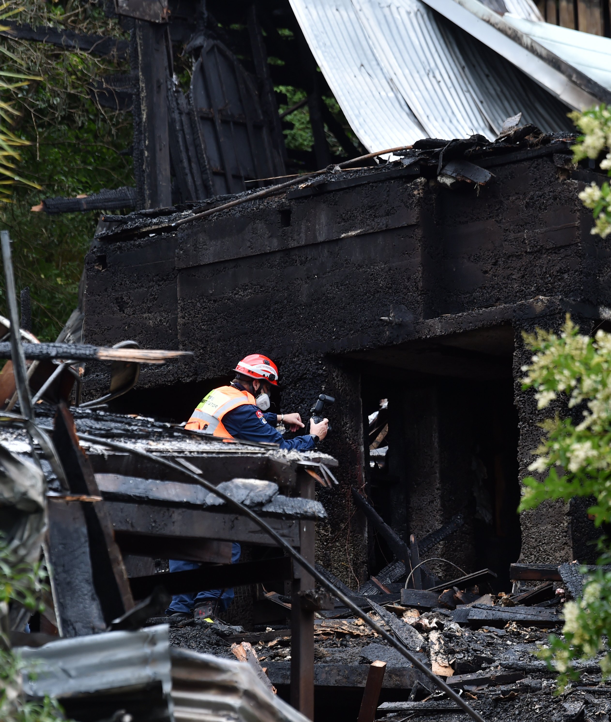 A Fire and Emergency New Zealand fire inspector conducts a scene examination to determine the...